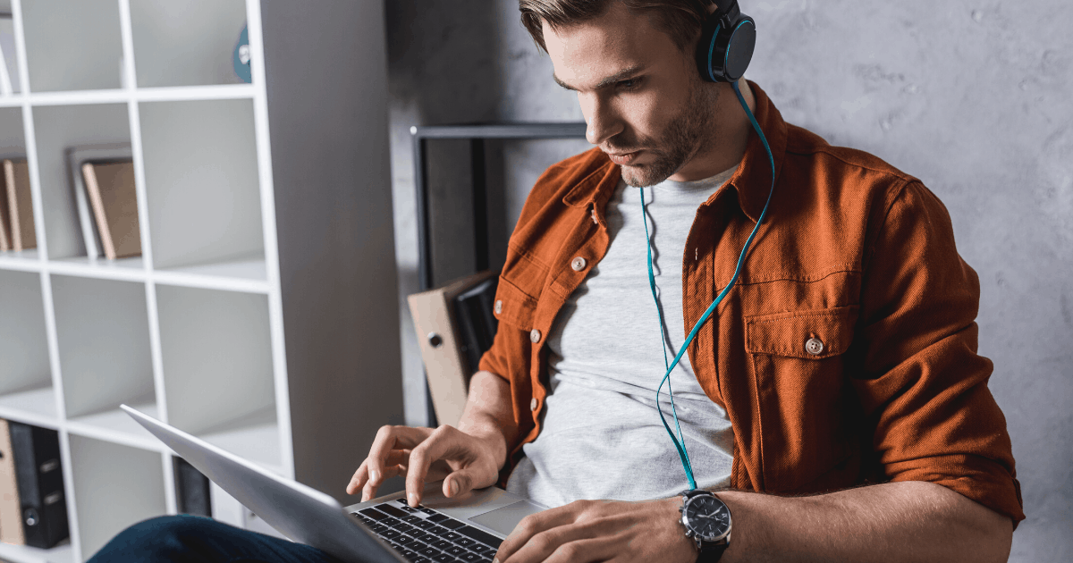 young man working on headphones at home